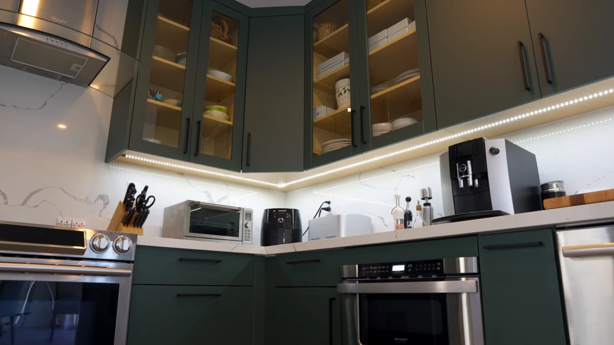 Verde Salvia Under Cabinet Lighting and items on top of CLassique Statuario Quartz Countertop