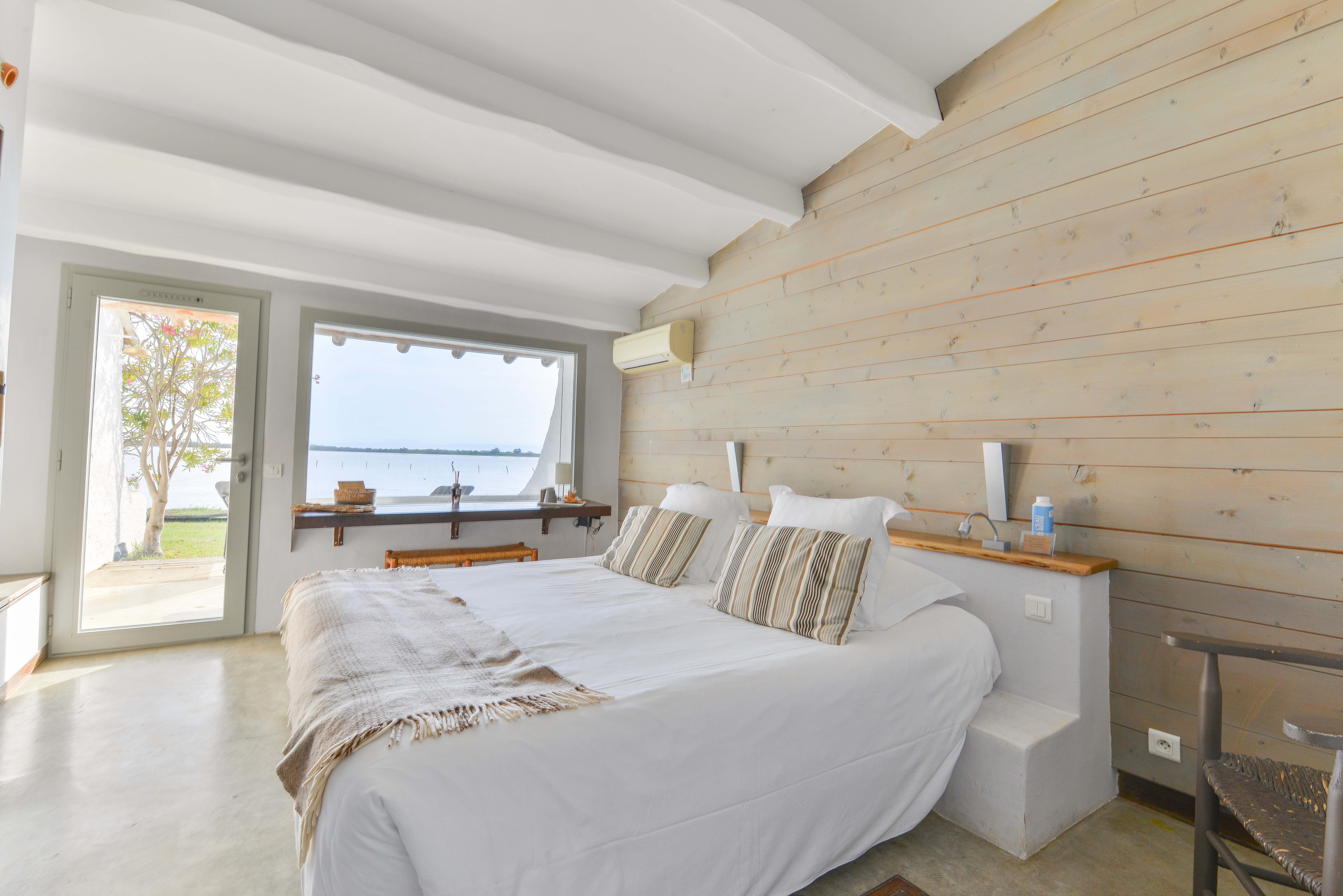 white bed linen with throw pillows