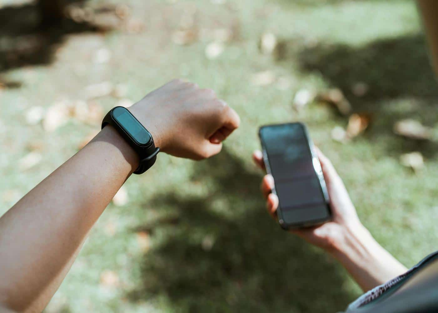 Person looking at smart watch and smartphone in front of them