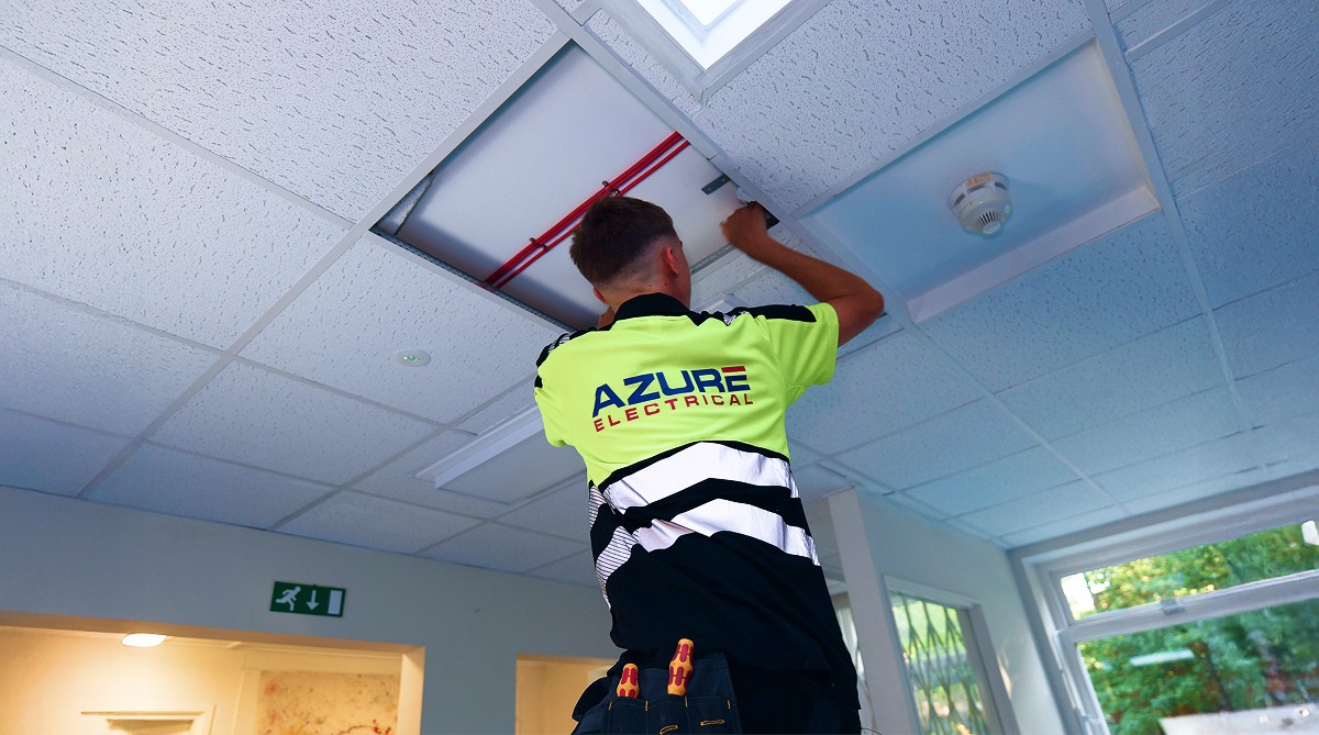 Memebr of the Azure Electrical Team doing an inspection of a Schools electrical system