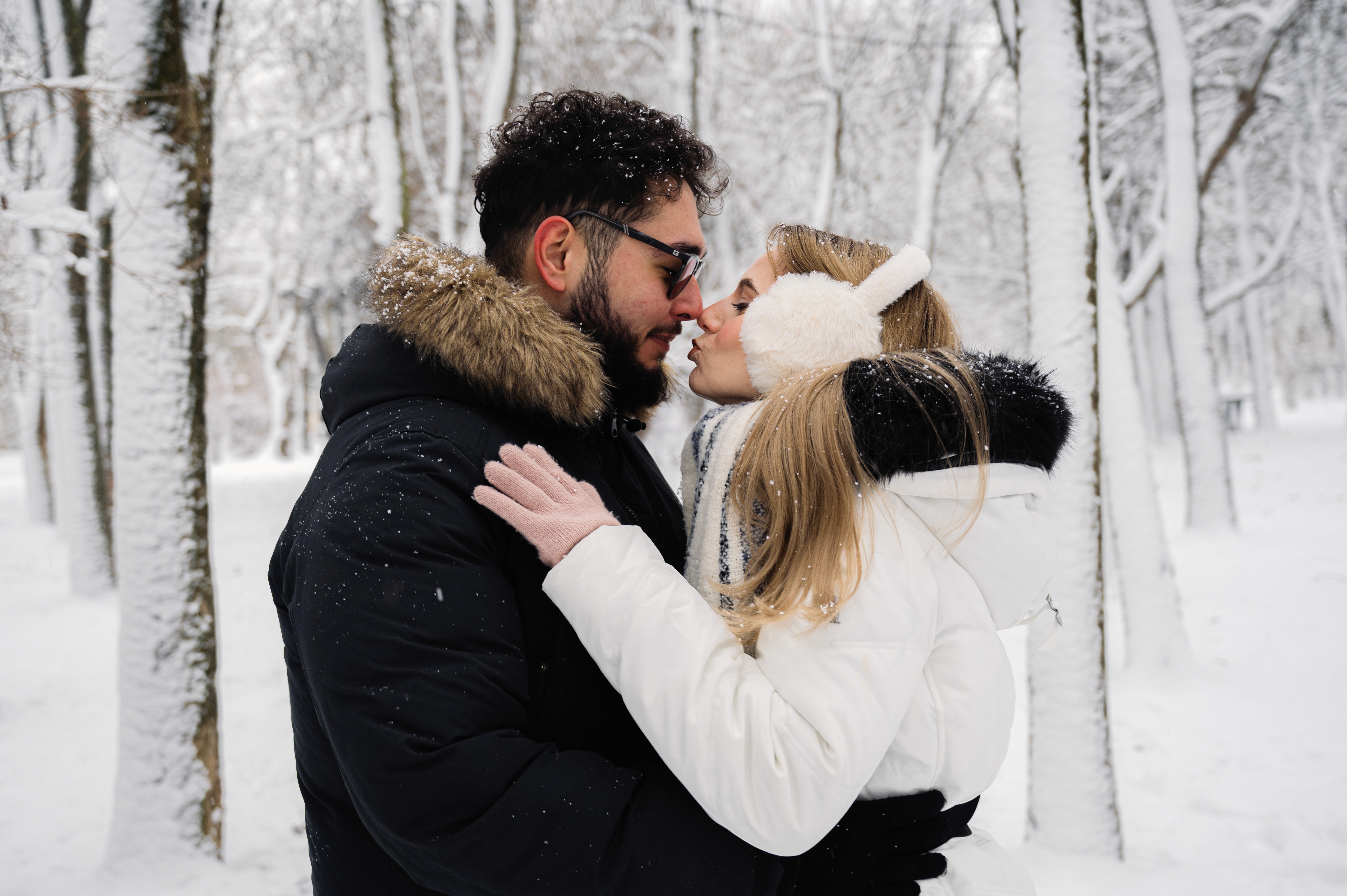 Ședință foto Save the Date realizată iarna, cu un cuplu elegant, într-un parc acoperit de zăpadă