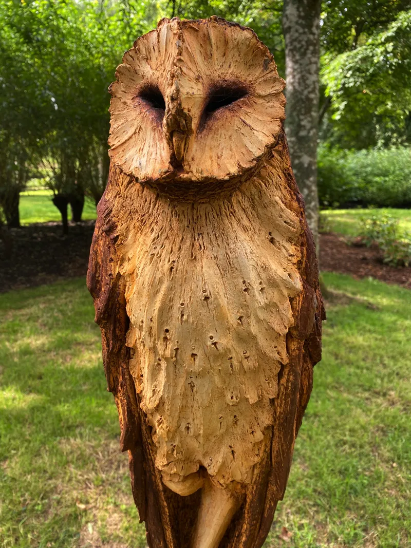 Owl posting sculpture in garden