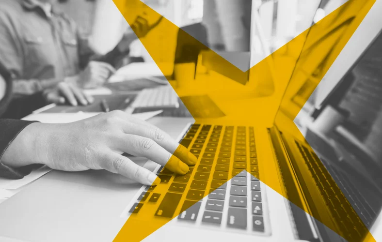 Technology professional working on laptop, representing AI-driven product development and automation