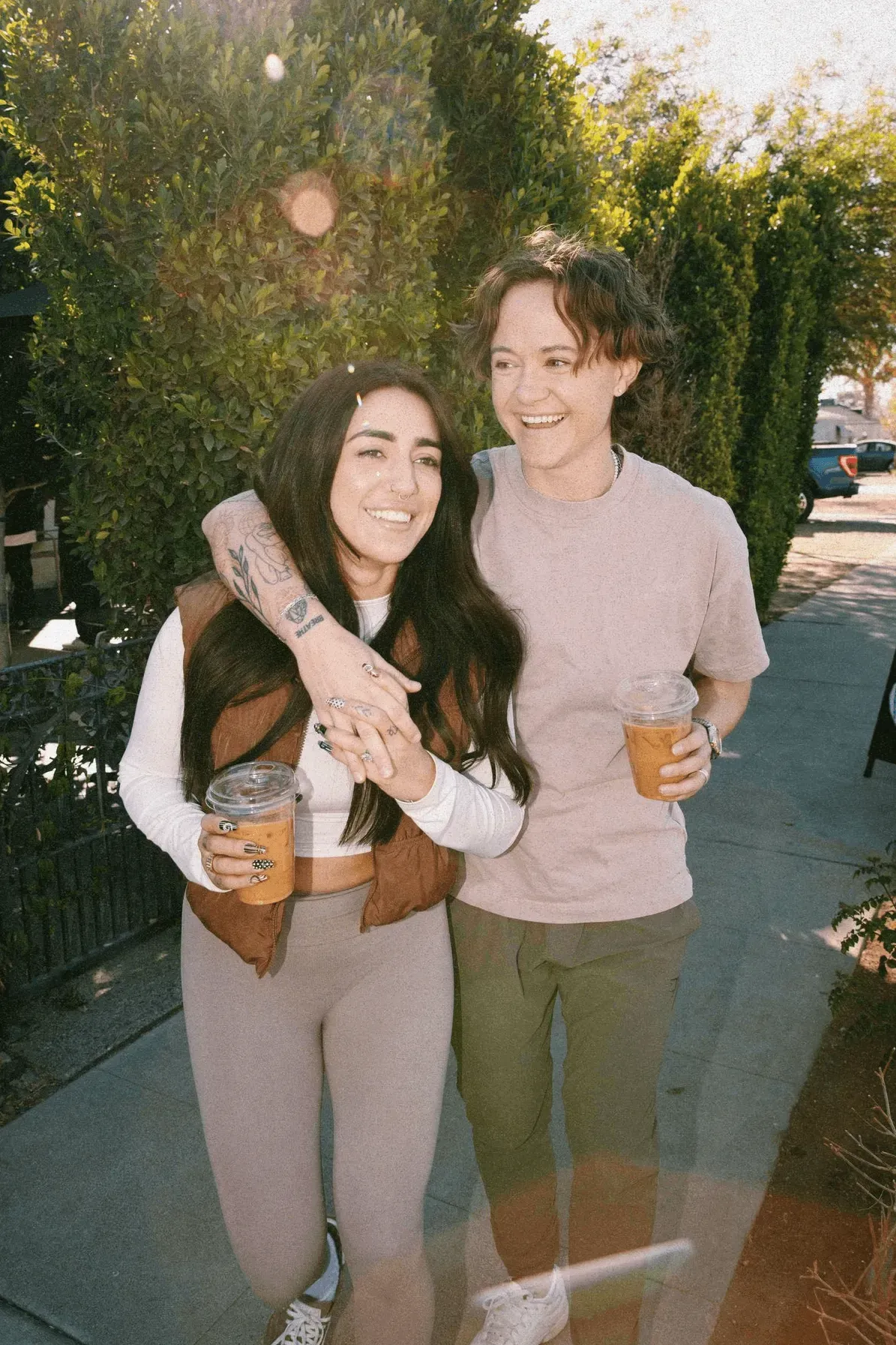 Two women smiling with their arms around each other.