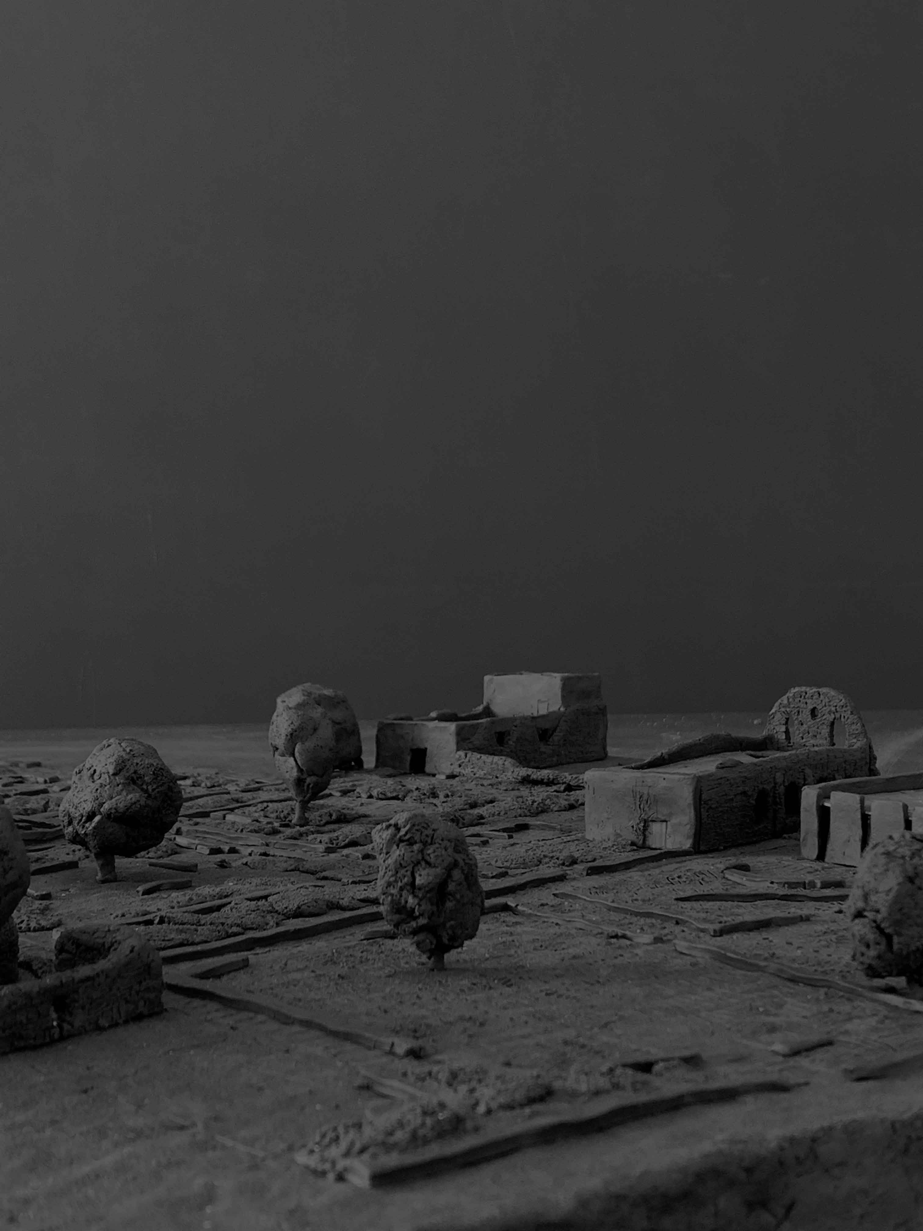 A modern, minimalist interior with wooden flooring, large windows, and a few plants giving a bright, airy feel.