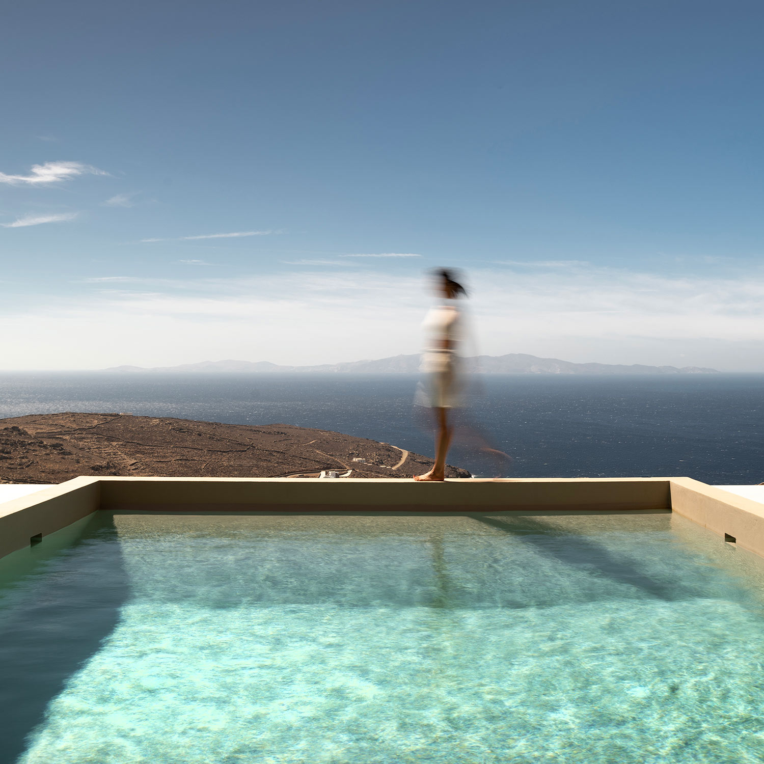 Infinity pool with a guest walking at the edge