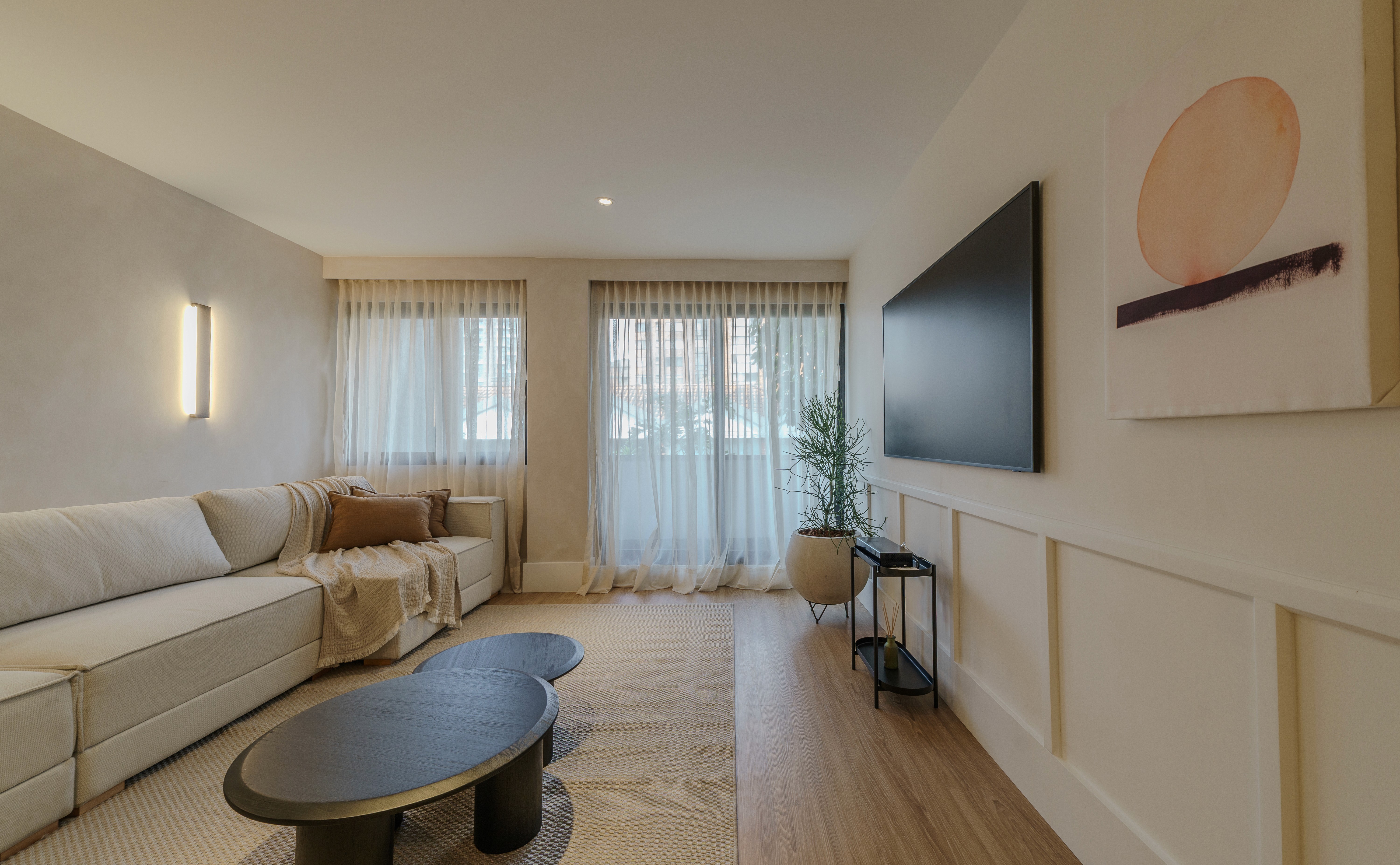 Double-height interior with flowing sculptural forms and warm raking light