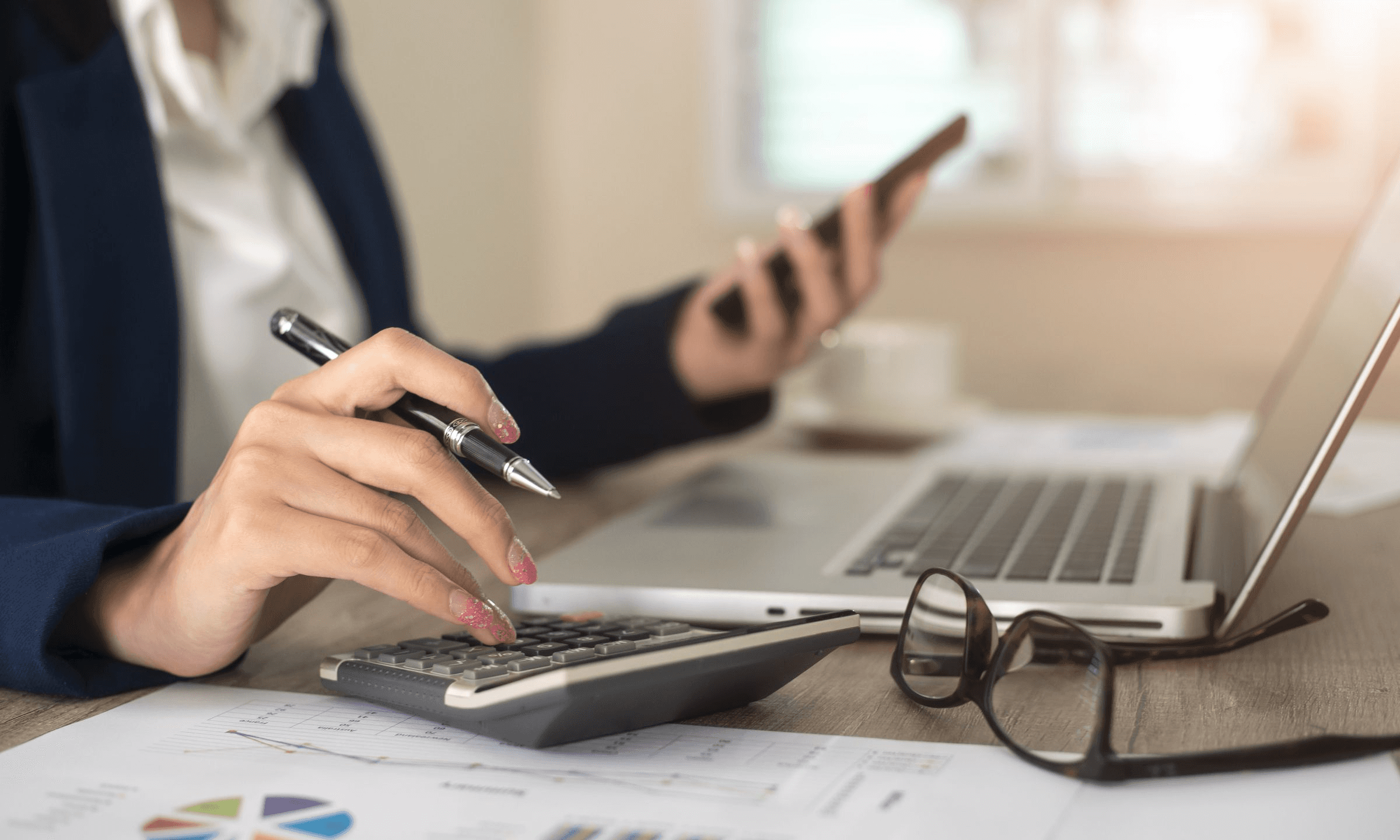 Woman using calculator -  How to Calculate Crypto Gains 