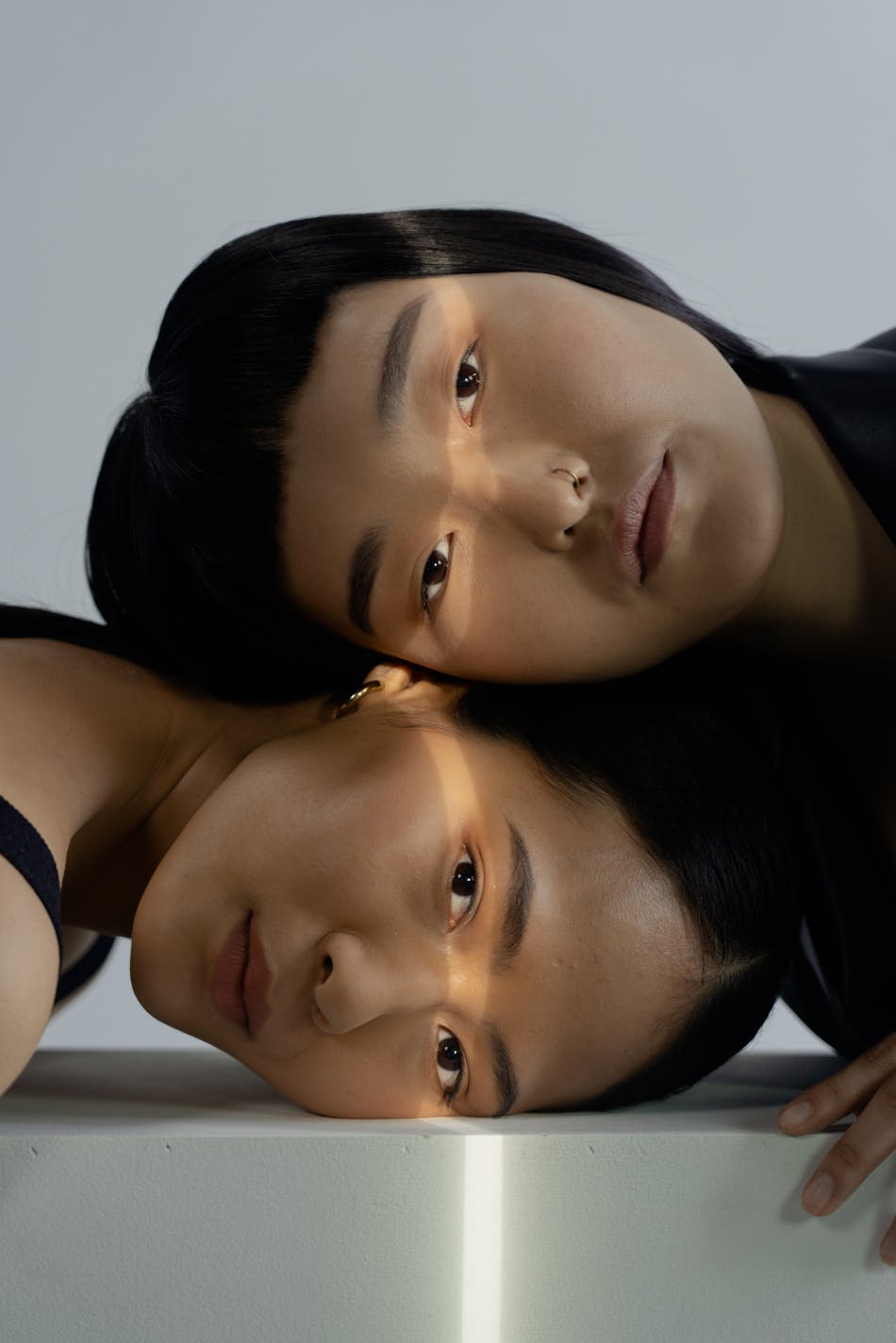 Persons heads on a white surface