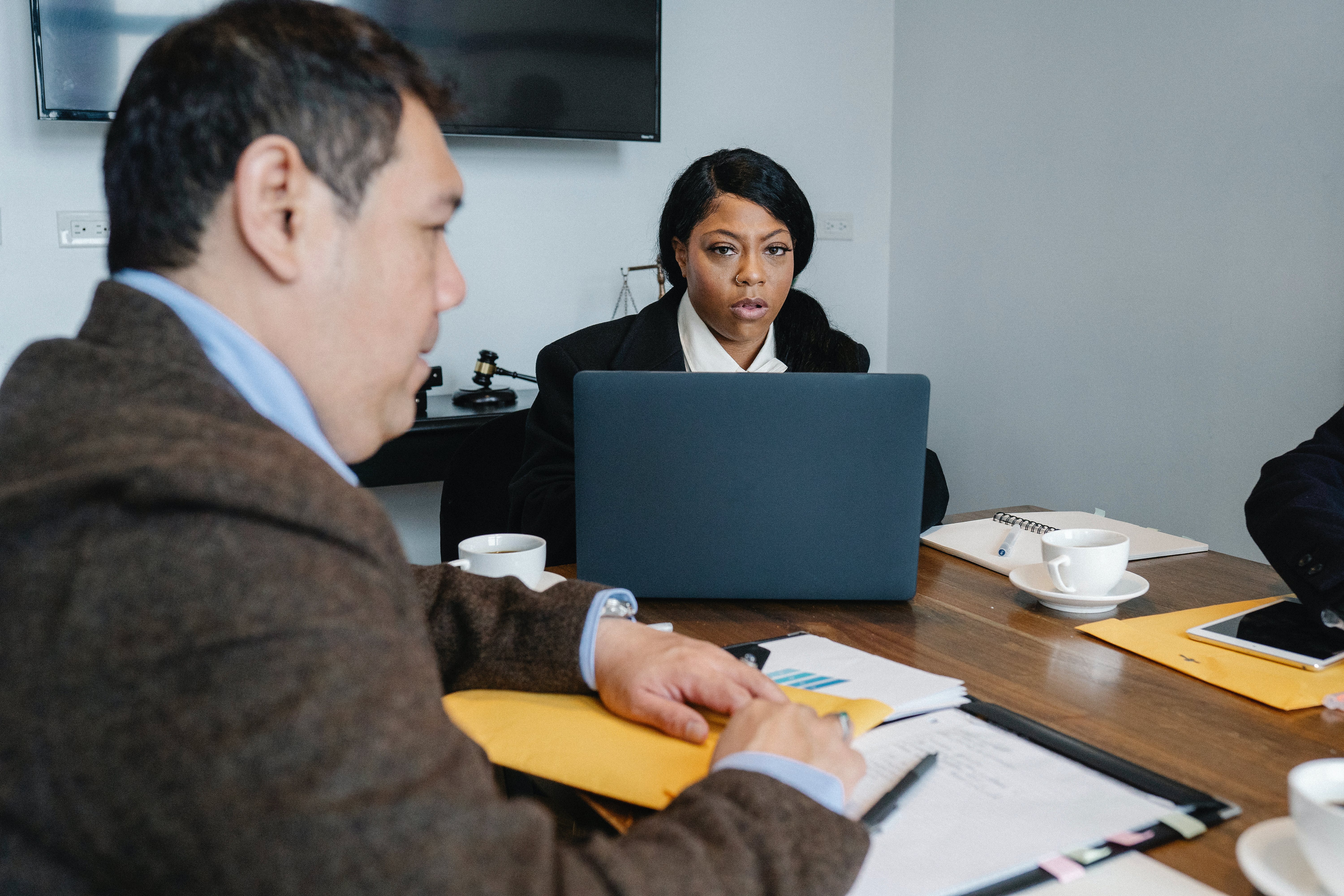 Colleagues having meeting in office about unwanted email law