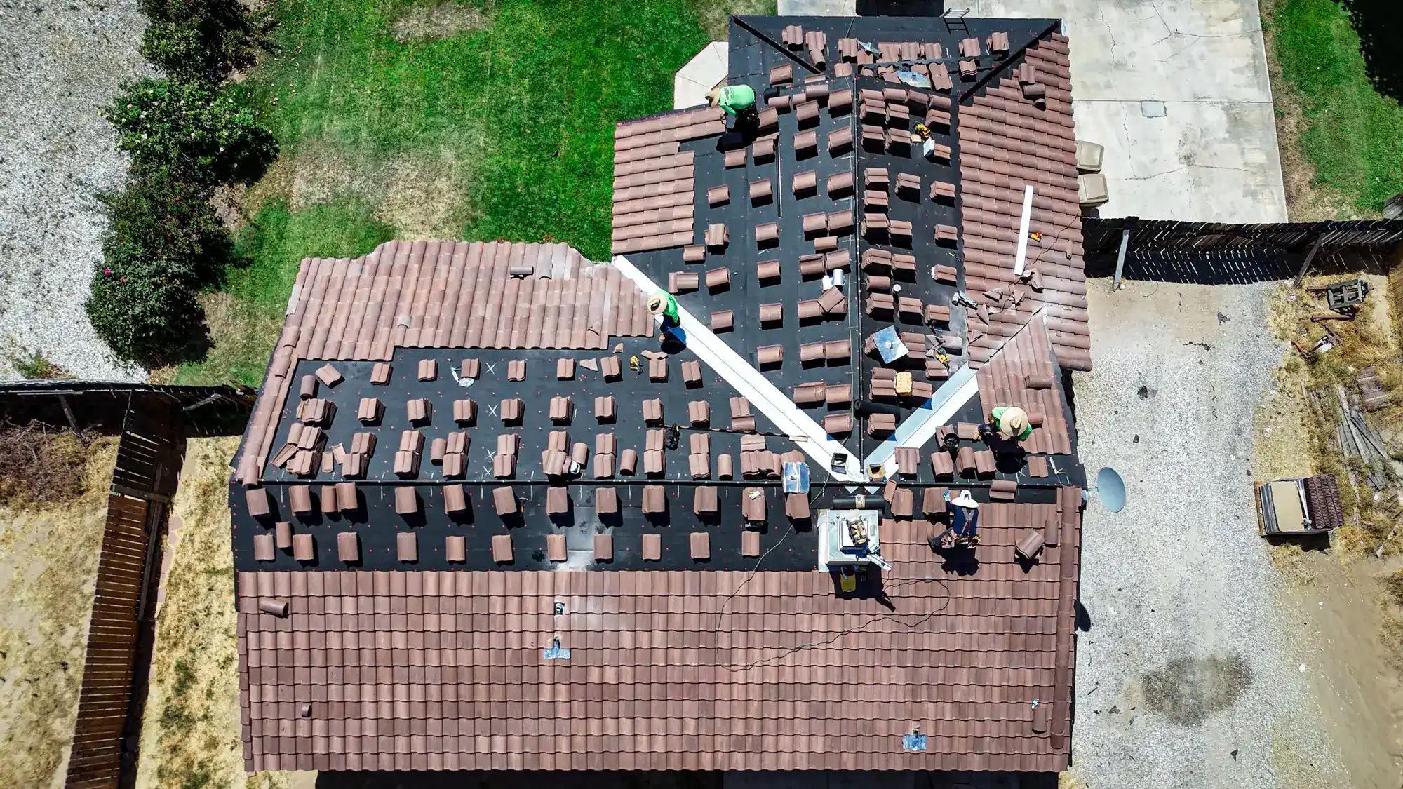 Tile roof being restored with tiles lifted for underlayment repair