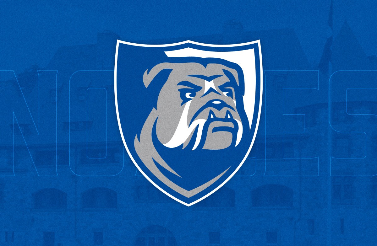 Nobles Athletics bulldog crest logo on blue background.