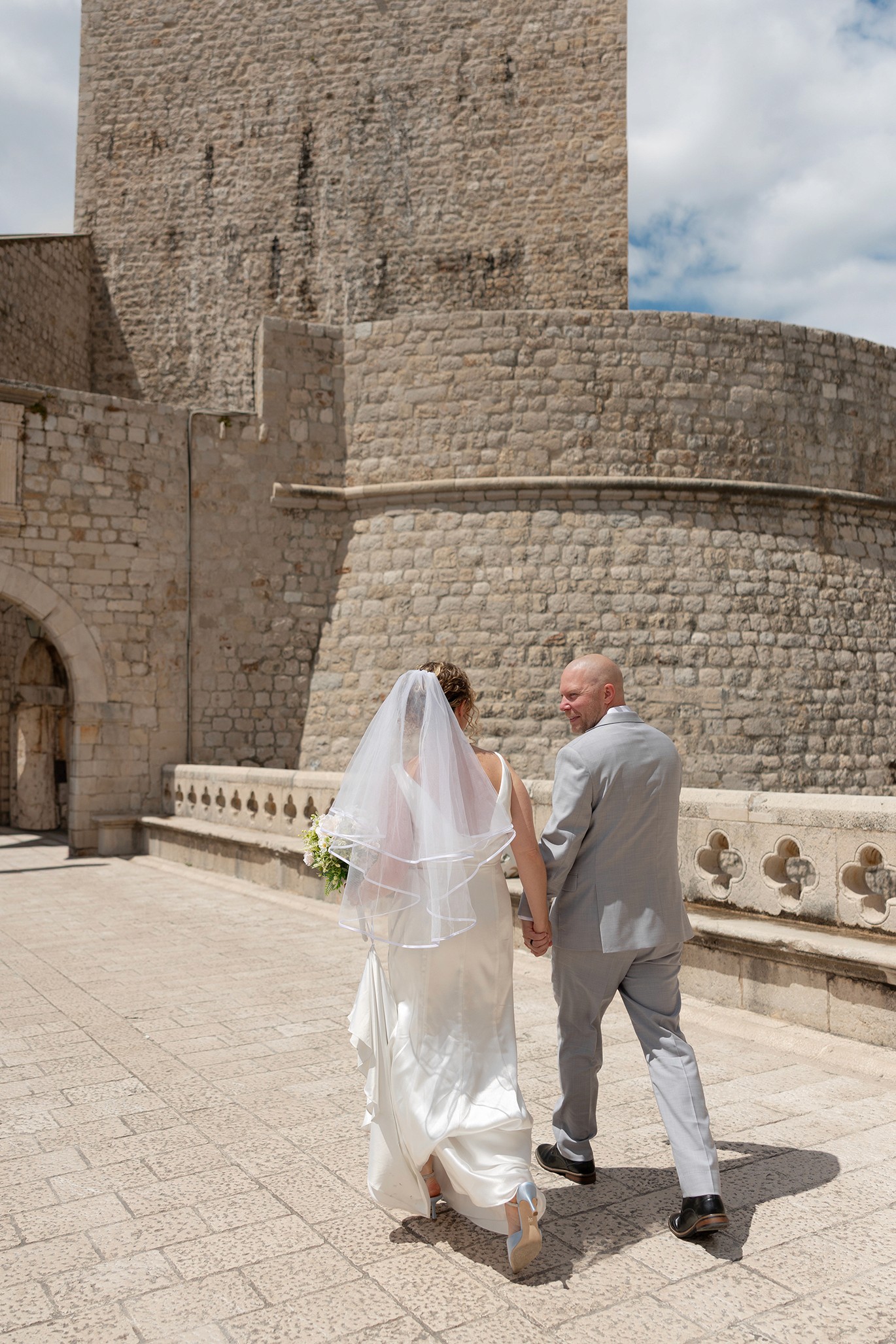 Bride and groom walking up steps together