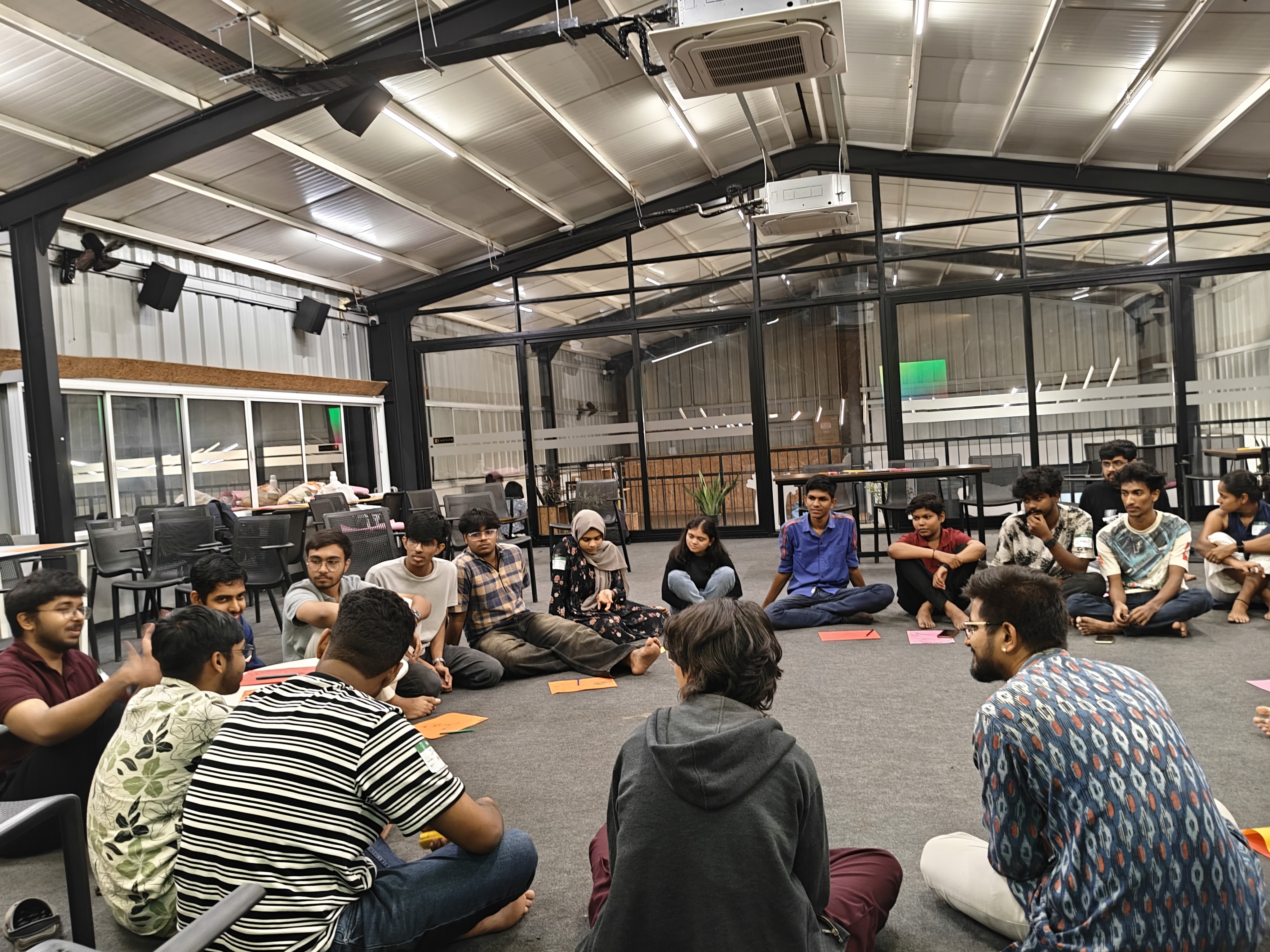 A group discussion at JI 101 where participants are seated together in a circle