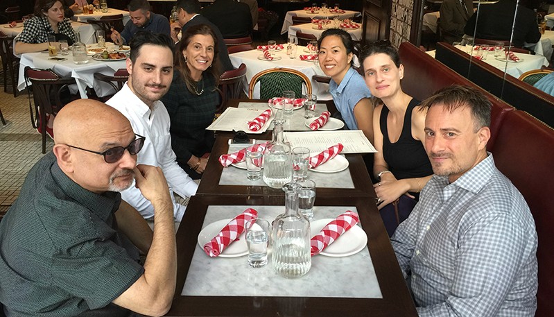 A photo of a group of people sitting at a restaurant table.
