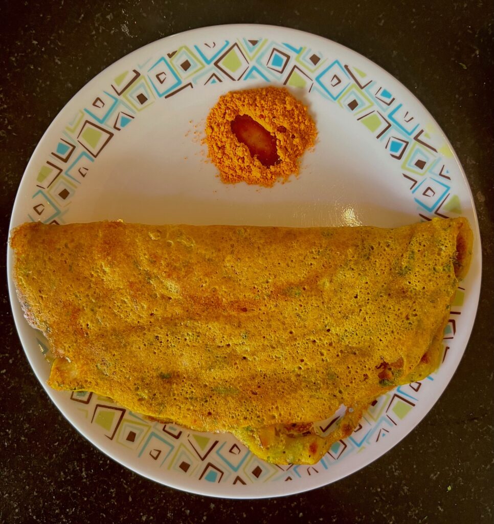 Adai, a crispy lentil dosa served with chutney podi and sesame oil. 