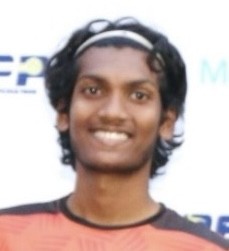 man in gray crew neck t-shirt and gray shorts sitting on basketball court