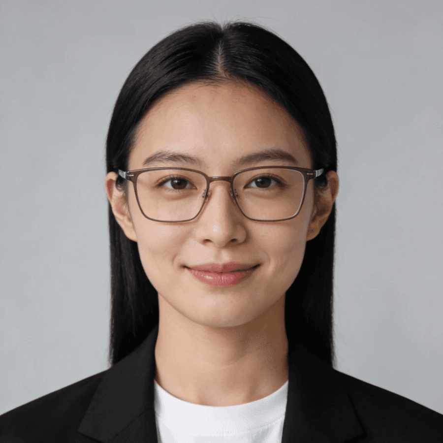 Professional portrait of a young woman with glasses, black hair, and a blazer, perfect for business or profile use.