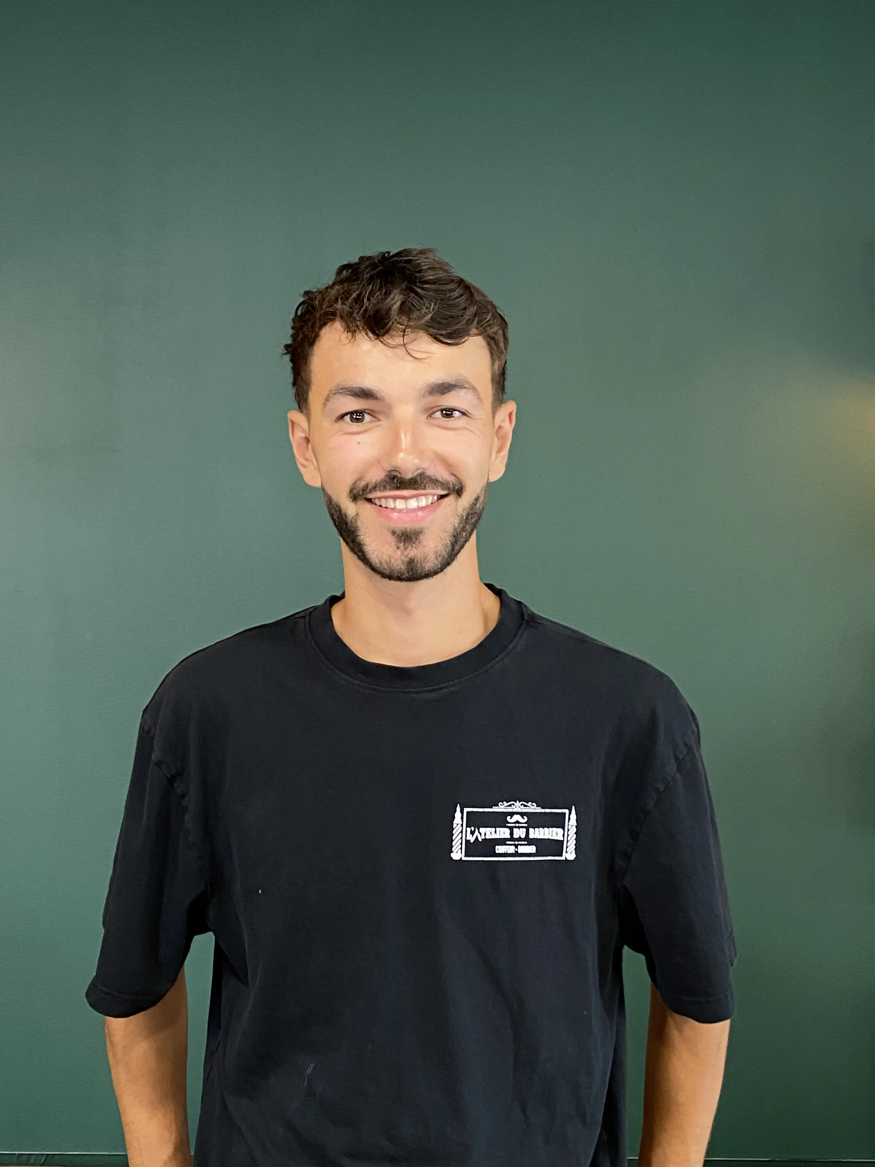woman looking sideways leaning on white wall