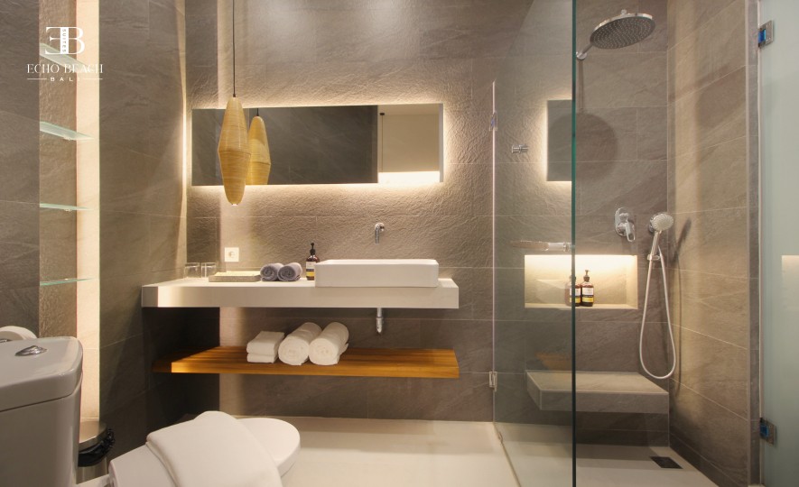 Elegant and modern vanity area with vessel sink and illuminated mirror in one of the three bathroom suites at Echo Beach Suite, Canggu, Bali.