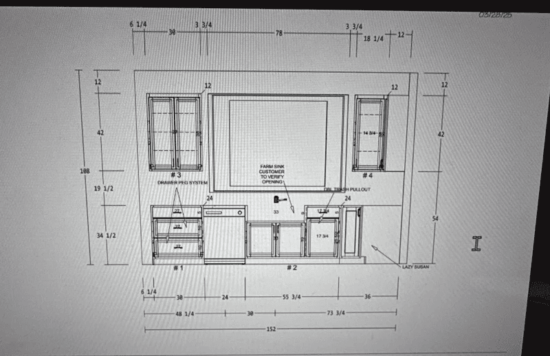 Two people walk past a construction cone.