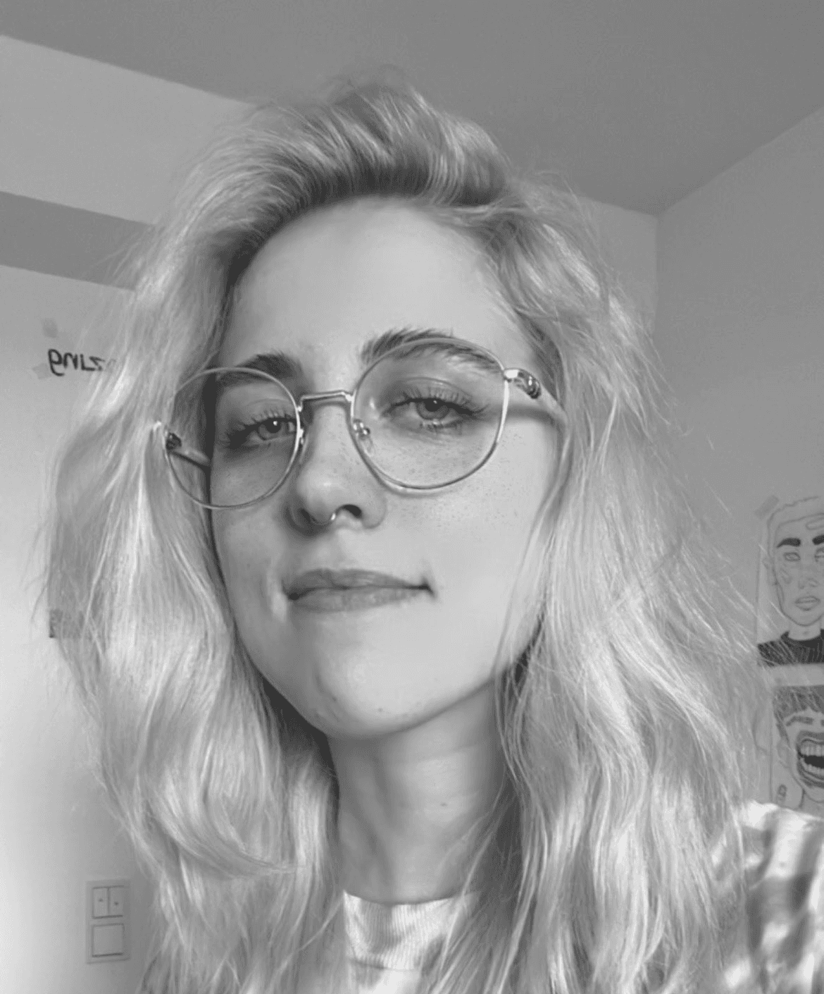 Portrait of man looking to the left and smiling with a dark background