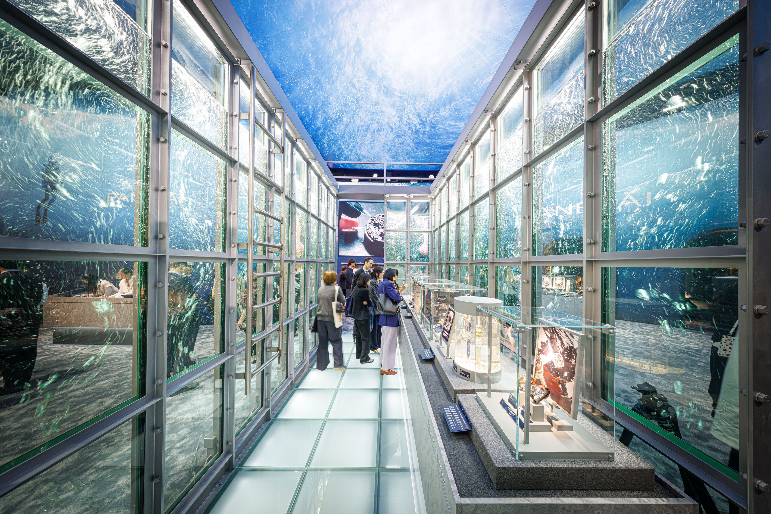 Panerai immersive water-themed booth with aquarium-style glass walls and watch displays