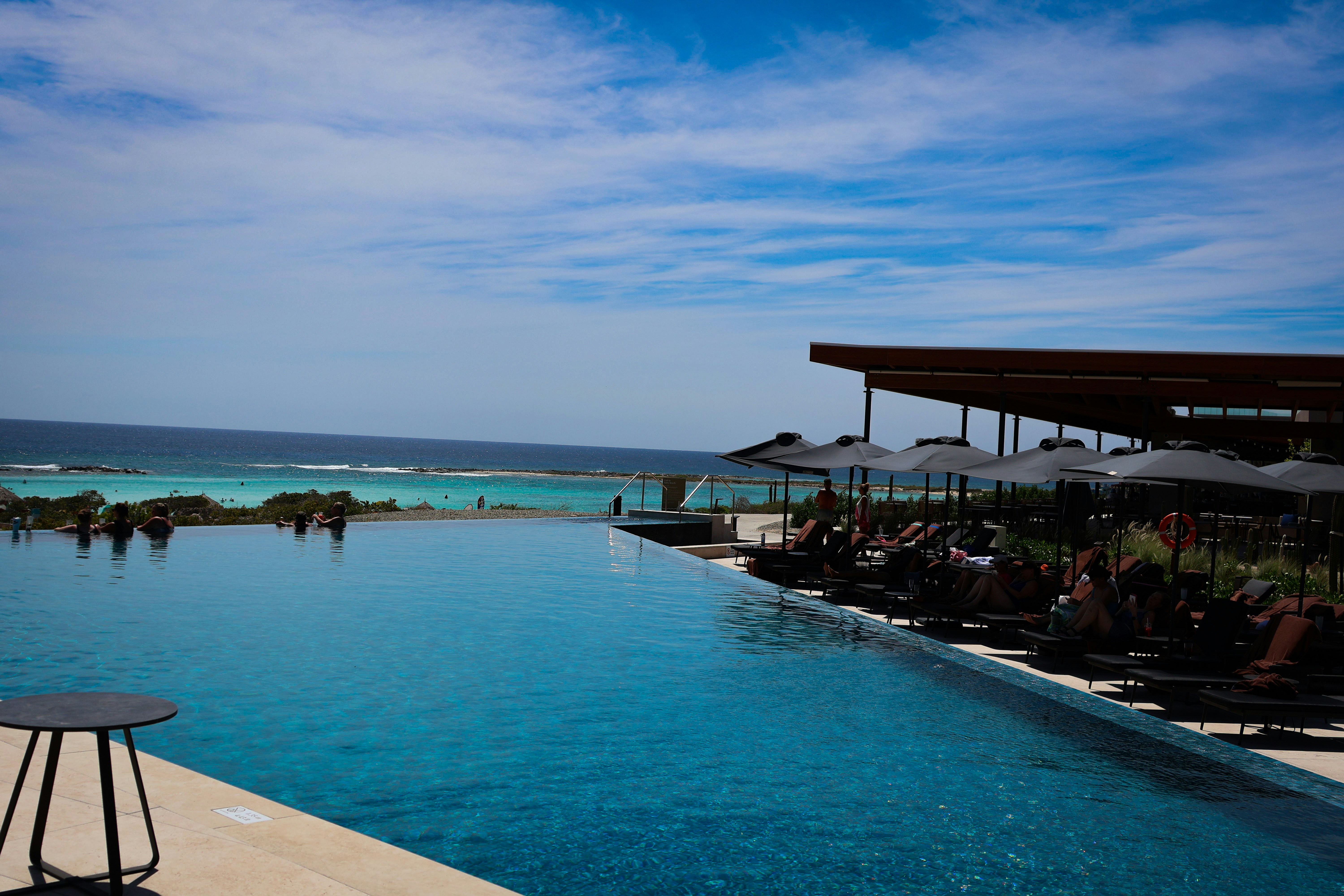 Infinity pool overlooking the ocean on a sunny day