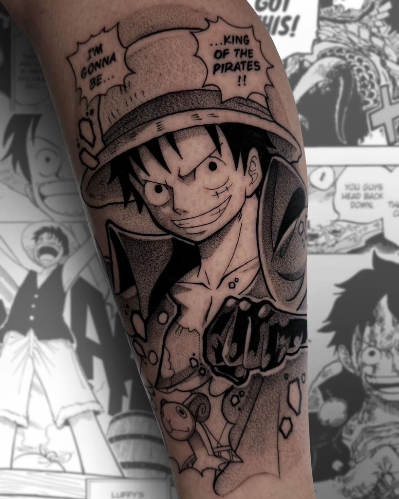 A black and grey tattoo of Luffy declaring his iconic goal to become the King of the Pirates, with bold outlines and dot work to emphasize the manga-inspired design.