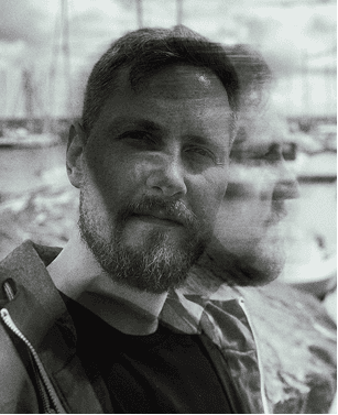 a blurry photo of a person standing in front of a wall