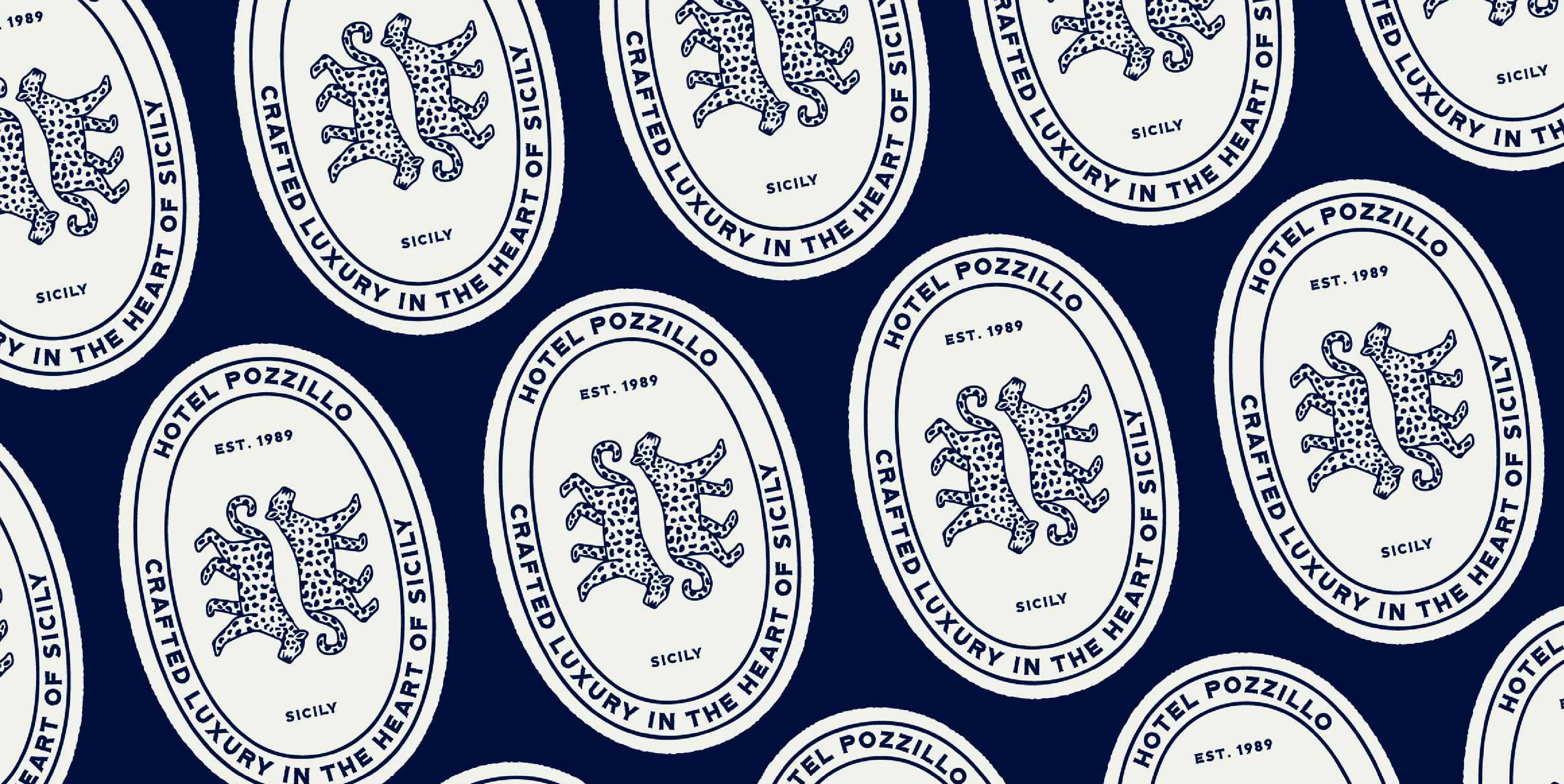 A repeated badge emblem logo pattern on a blue backgrounds, featuring a double leopard motif