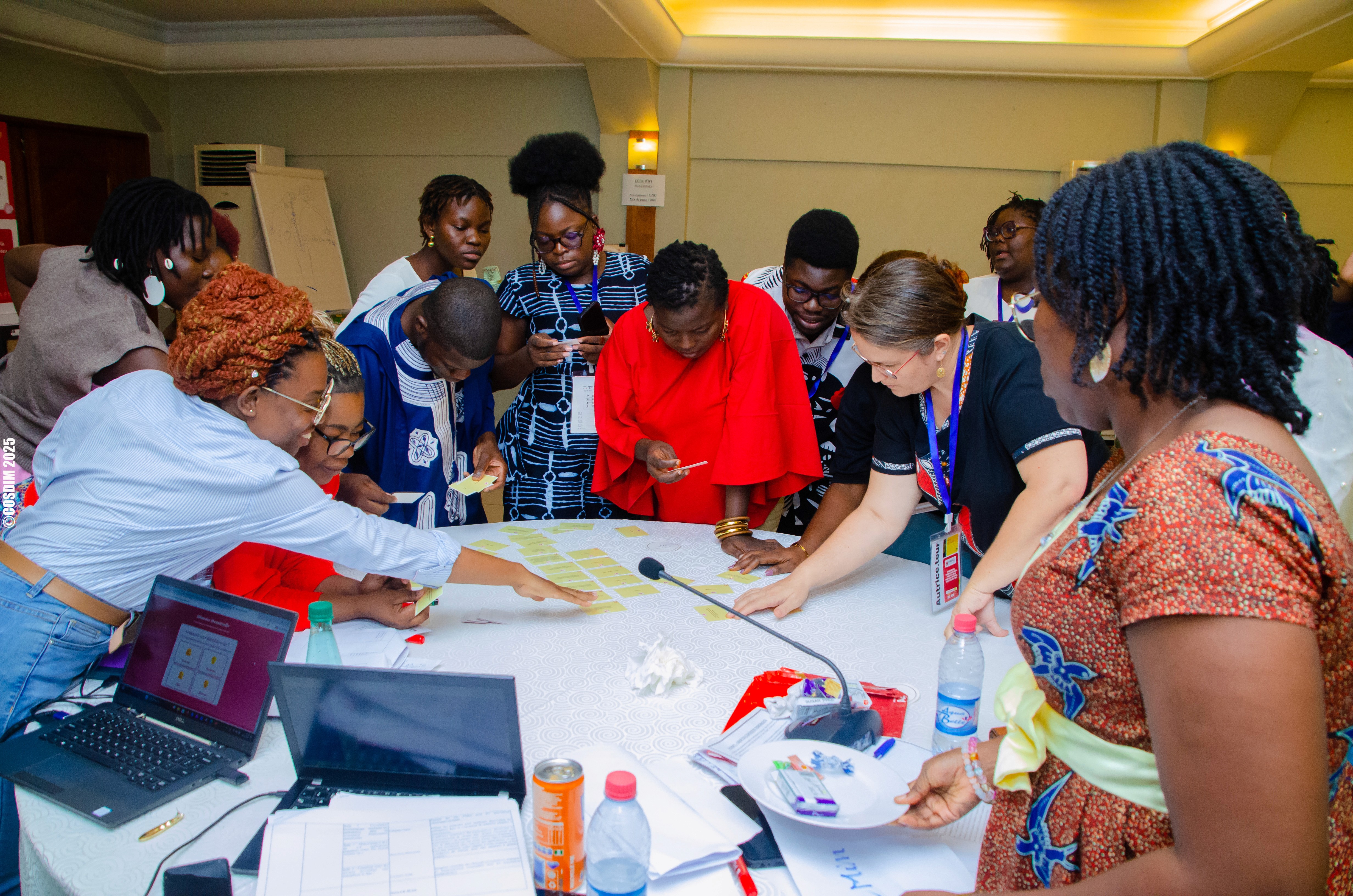 Close-up of lush, dark green leaves, some glossy and wet, against a muted background.