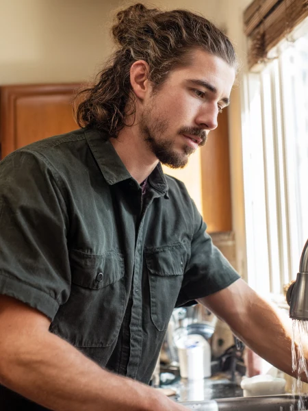 plumber working in kitchen 