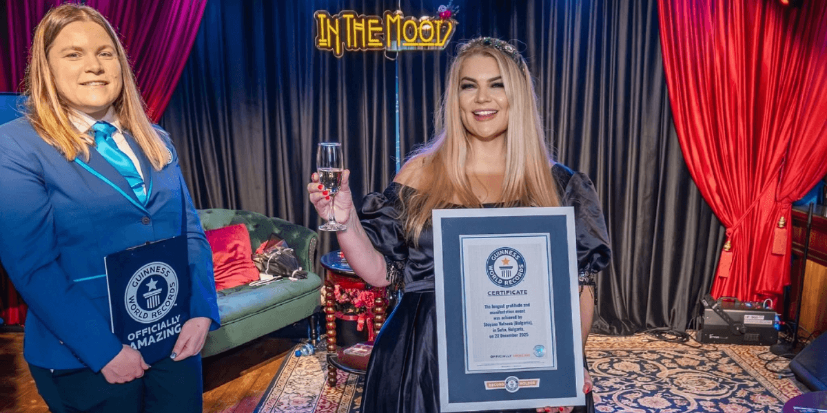 Professor Dr. Stoyana Natseva holding her Guinness World Records certificate alongside an official, celebrating her transformational literature achievement.