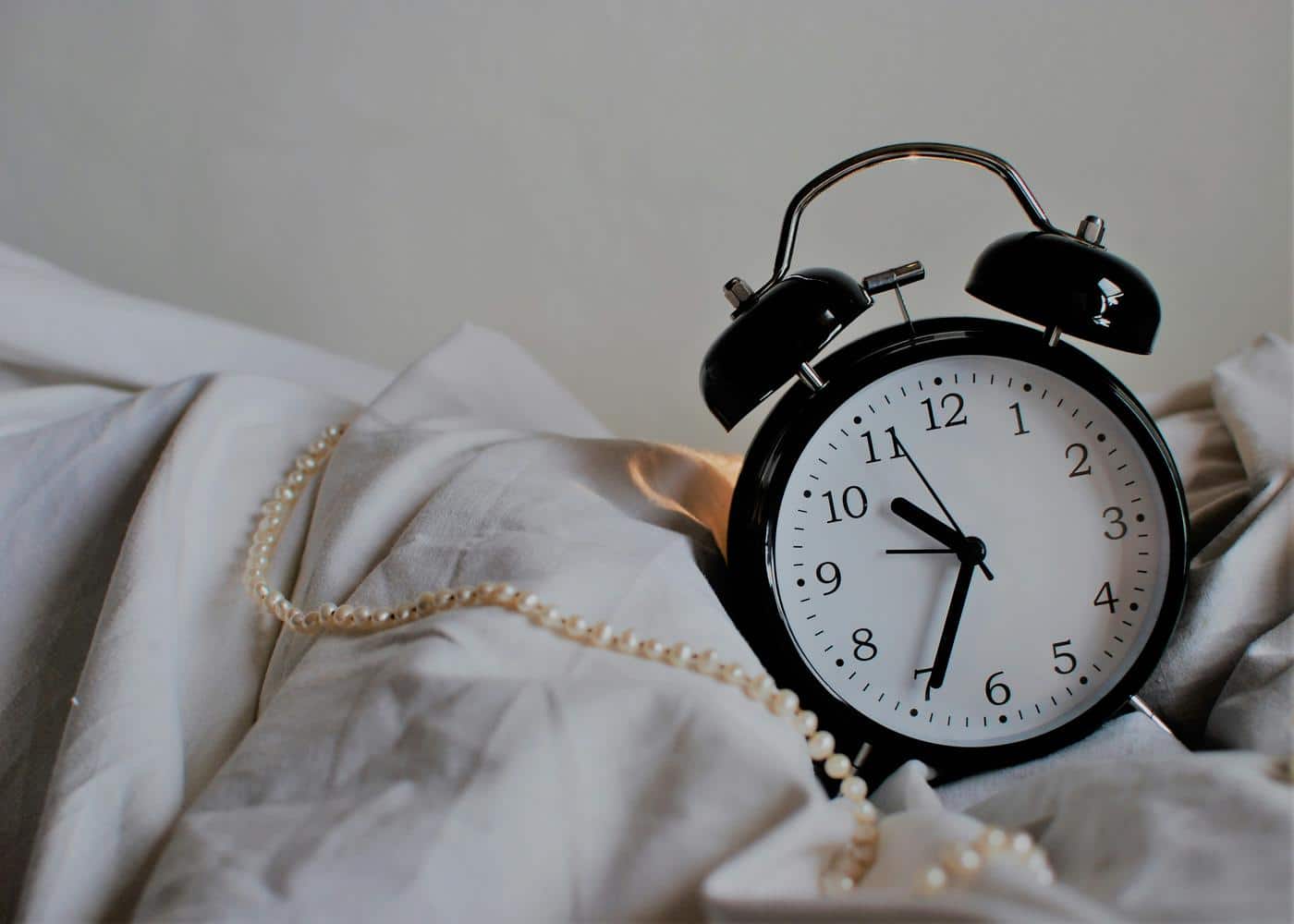Circadian rhythm - picture of an alarm clock on a bed
