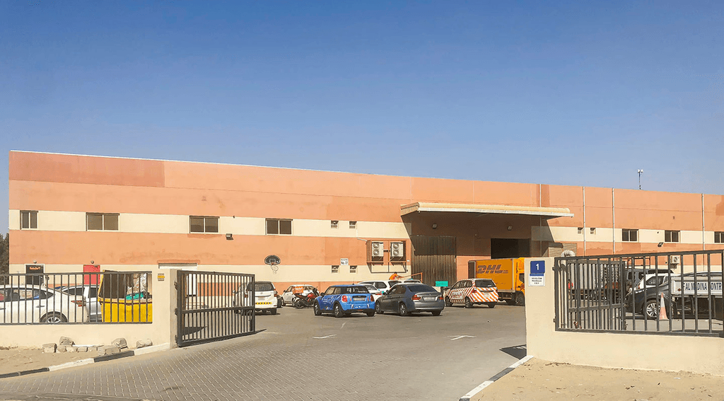 Exterior view of a healthcare center in Dubai Investment Park, featuring contemporary architecture and accessible entrances.