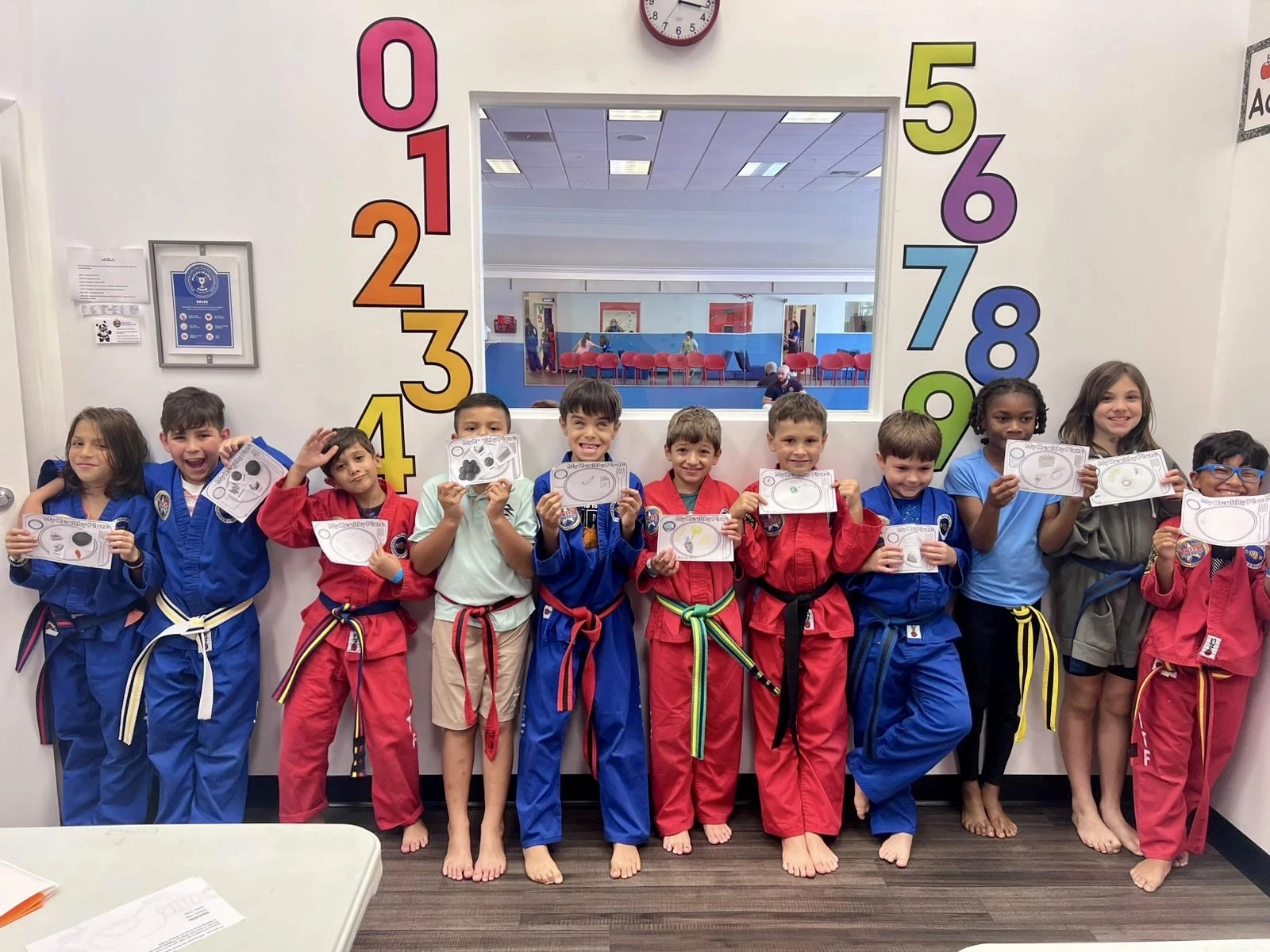 Photo of kids looking at a counselor performs an activity.