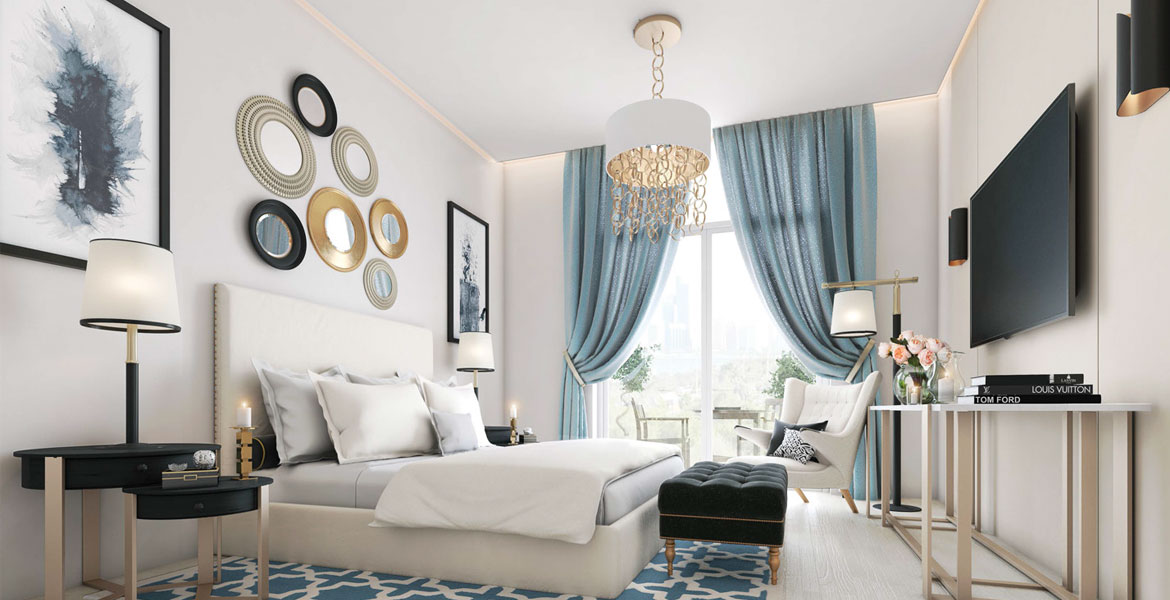 A chic living room adorned with blue and gold decor, reflecting the sophisticated design style of Candace Aster.