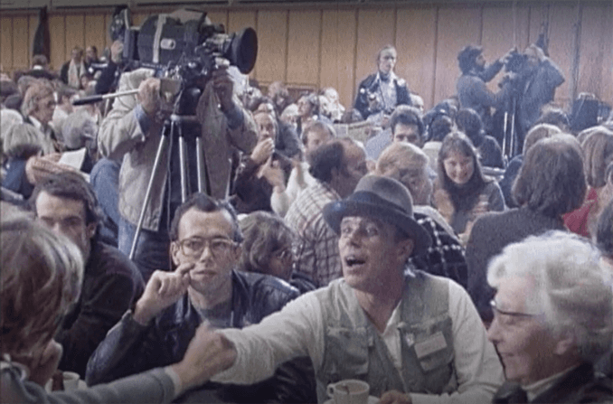 A group of people sitting in a room
AI-generated content may be incorrect.