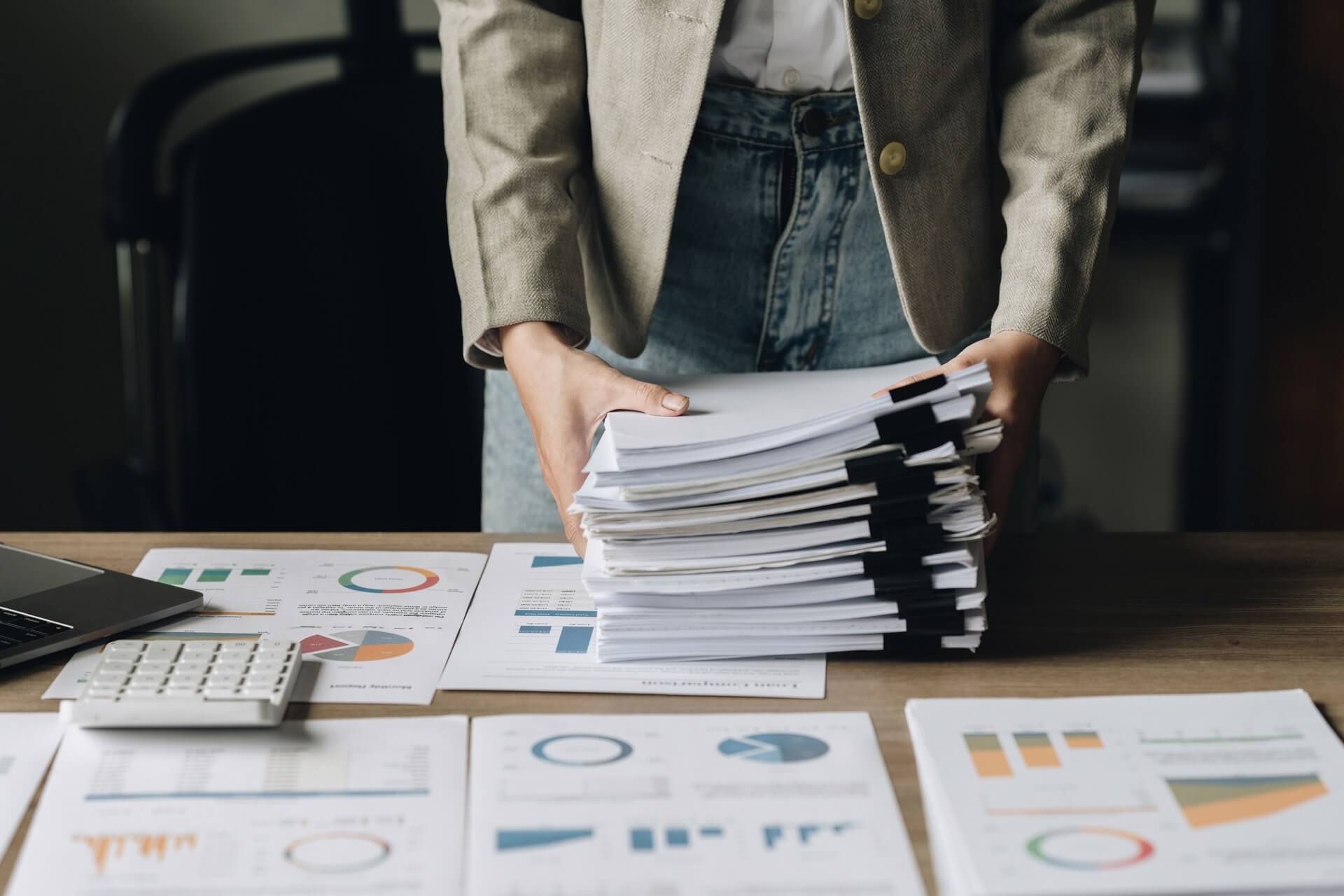 a man and a woman shaking hands in front of a laptop
