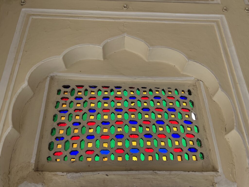 Blue Green and Red Stained Glass on a Wall