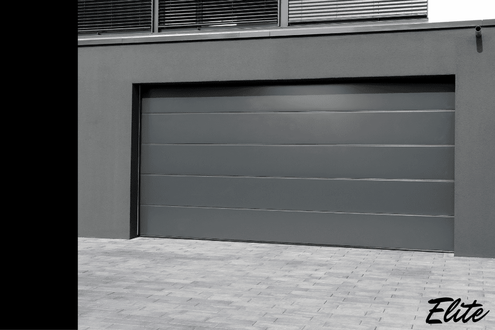 Sleek dark grey modern garage door finished by Elite Garage Door for NWA homeowners.