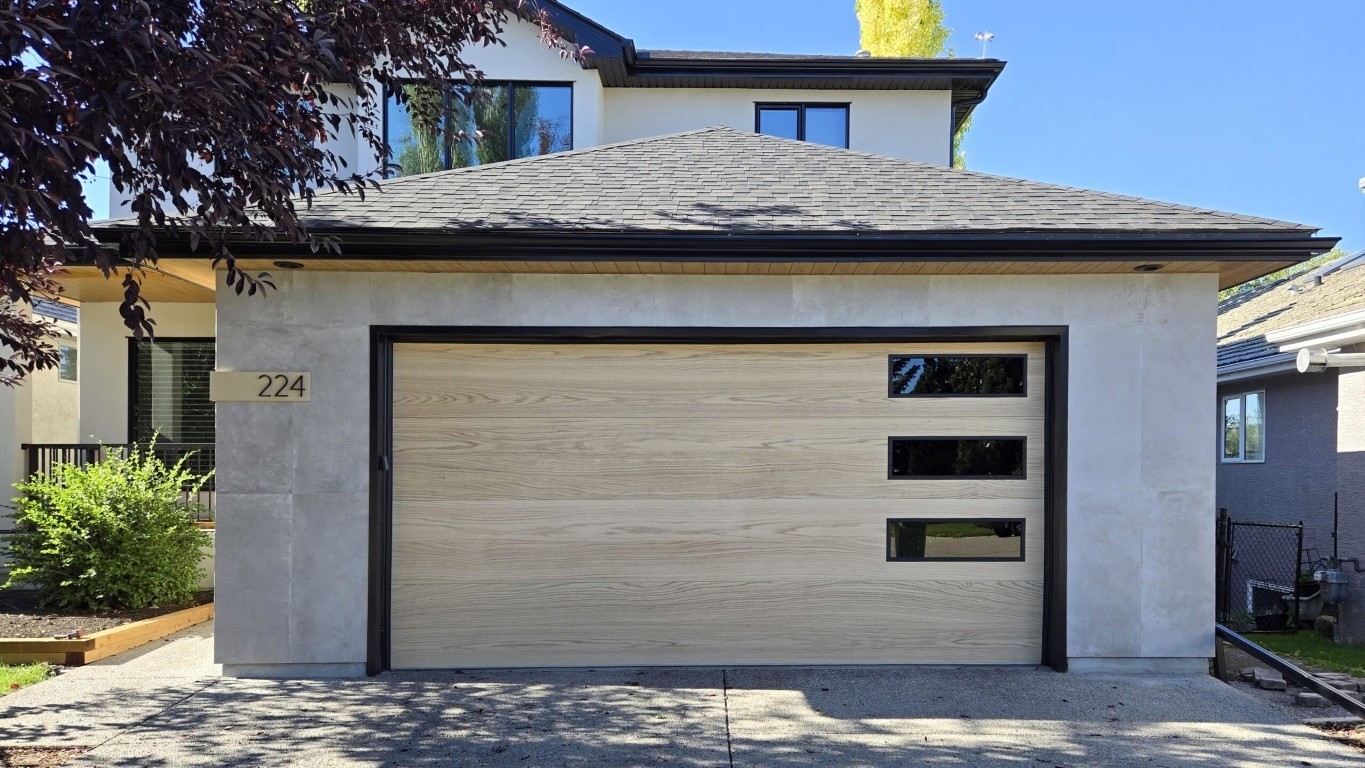 Image of KHD Homes modern garage design with wooden door and gray roof exterior home improvement construction.