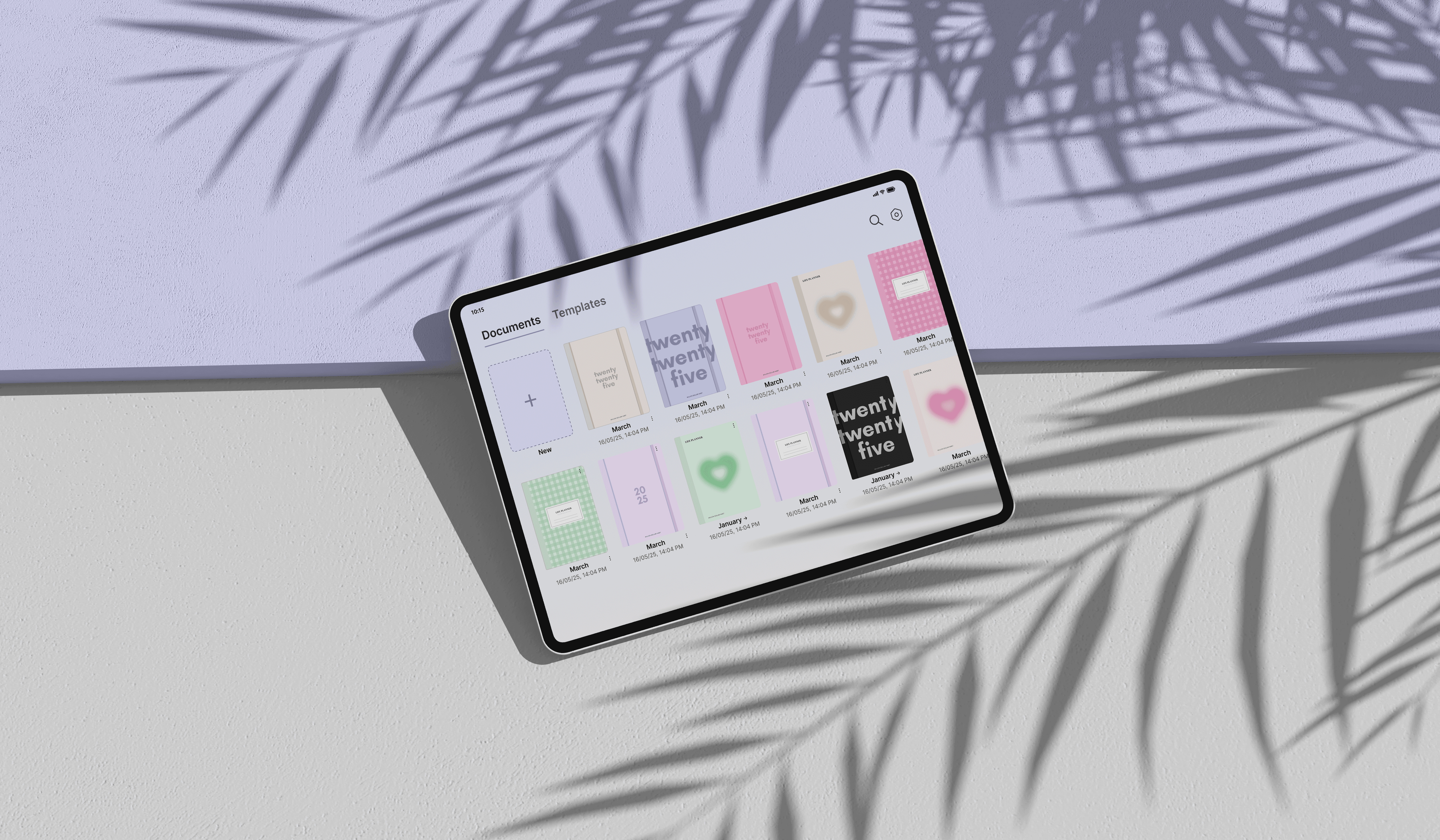 A woman in a colorful shirt sits at an outdoor table drawing on an iPad with an Apple Pencil.