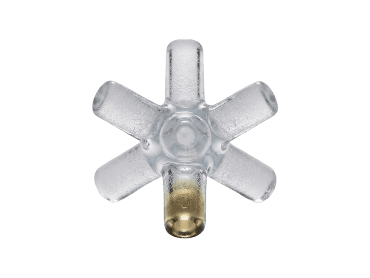 Small glass jack-shaped object with a gold sphere at its base, on a black background.