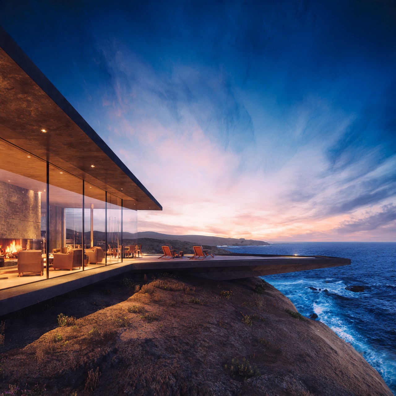 Modern glass-walled home on a cliff at sunset, overlooking the ocean. Warm, inviting interior lighting contrasts with the cool, dramatic sky and sea.