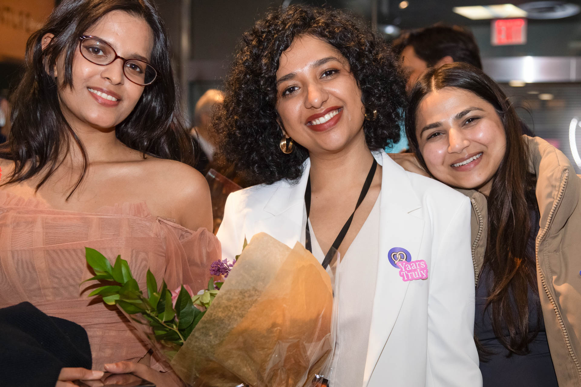 a group of students smiling for the camera in the SVA Theatre lobby after the Venture Forum