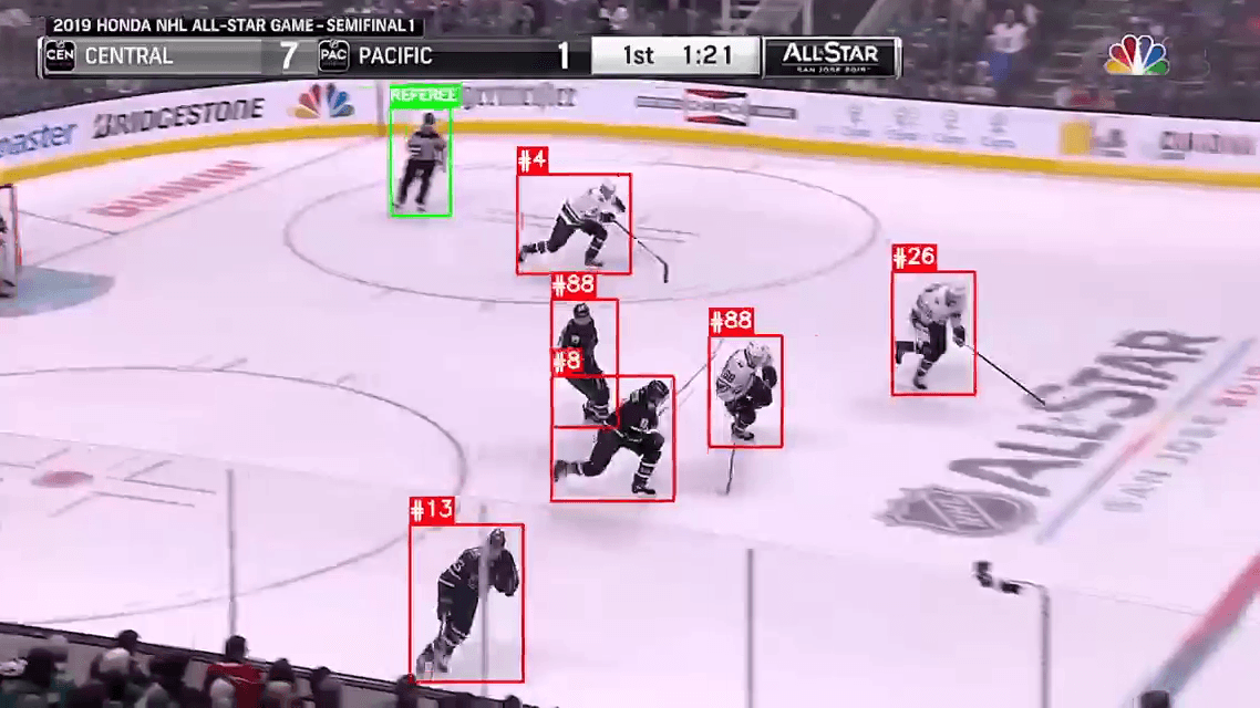 Ornate building with outdoor cafe seating in sunlight.