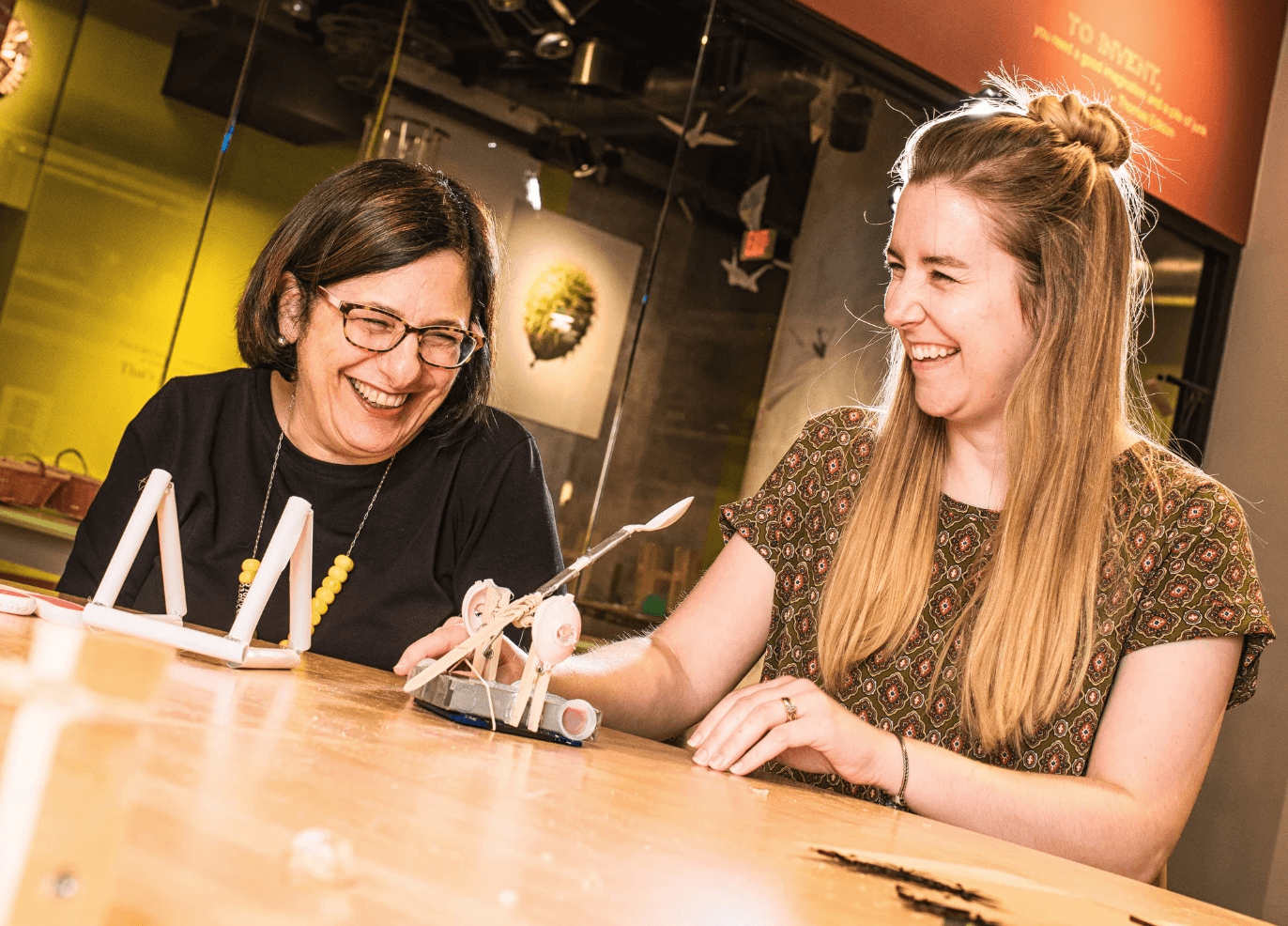 Two educators work together to build a project.