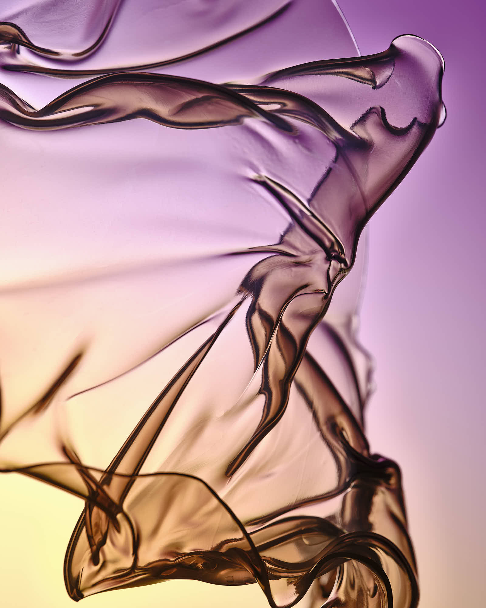 Abstract flowing fabric with purple and yellow gradient background.